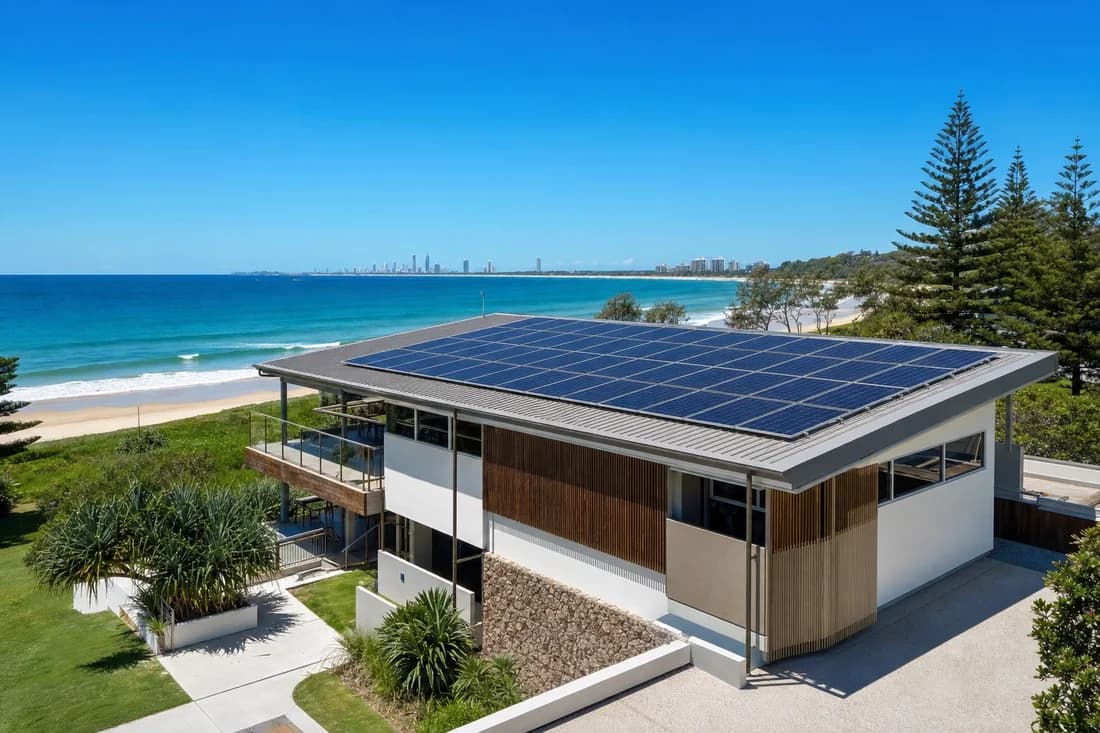 A coastal recreation building with solar panels across the roof