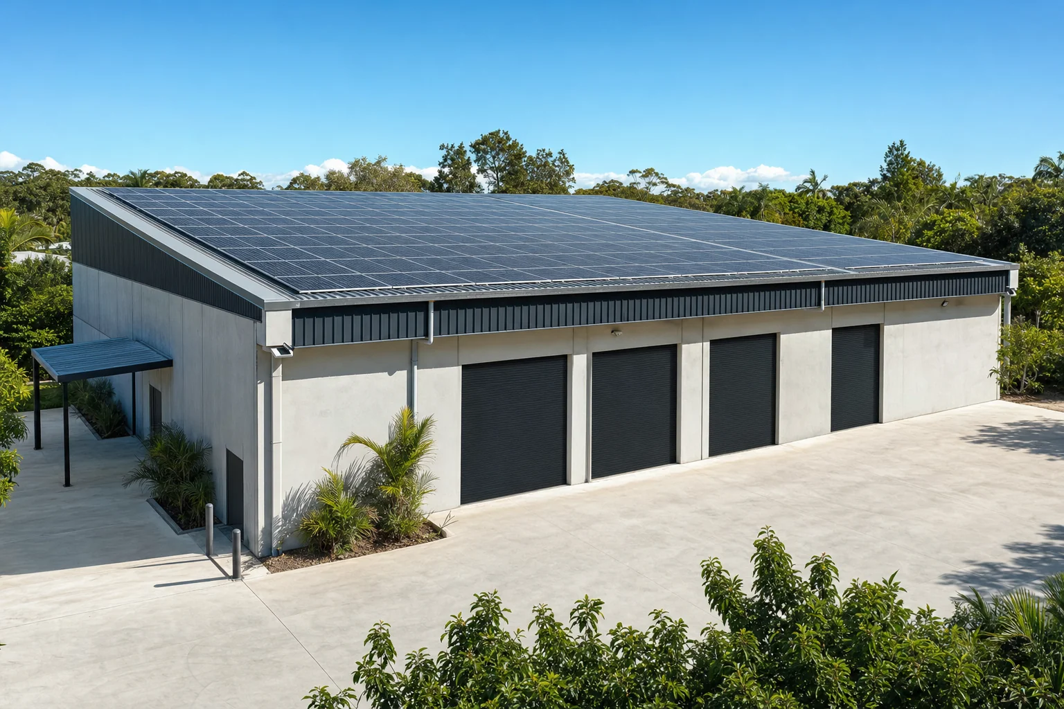 Solar array on the roof of a Gold Coast commercial warehouse building under clear sky